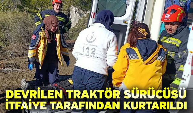 Devrilen traktör sürücüsü itfaiye tarafından kurtarıldı