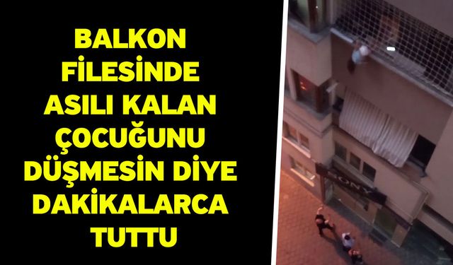 Balkon filesinde asılı kalan çocuğunu düşmesin diye dakikalarca tuttu